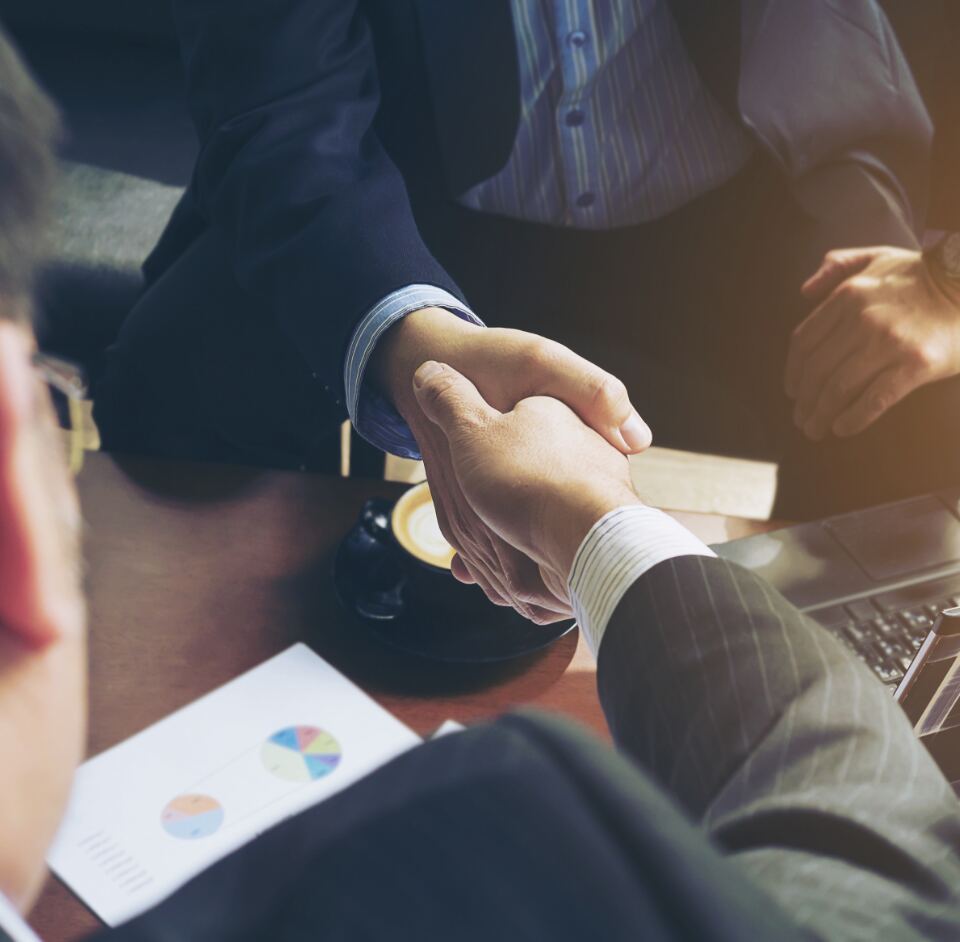 Business professionals shaking hands during a meeting